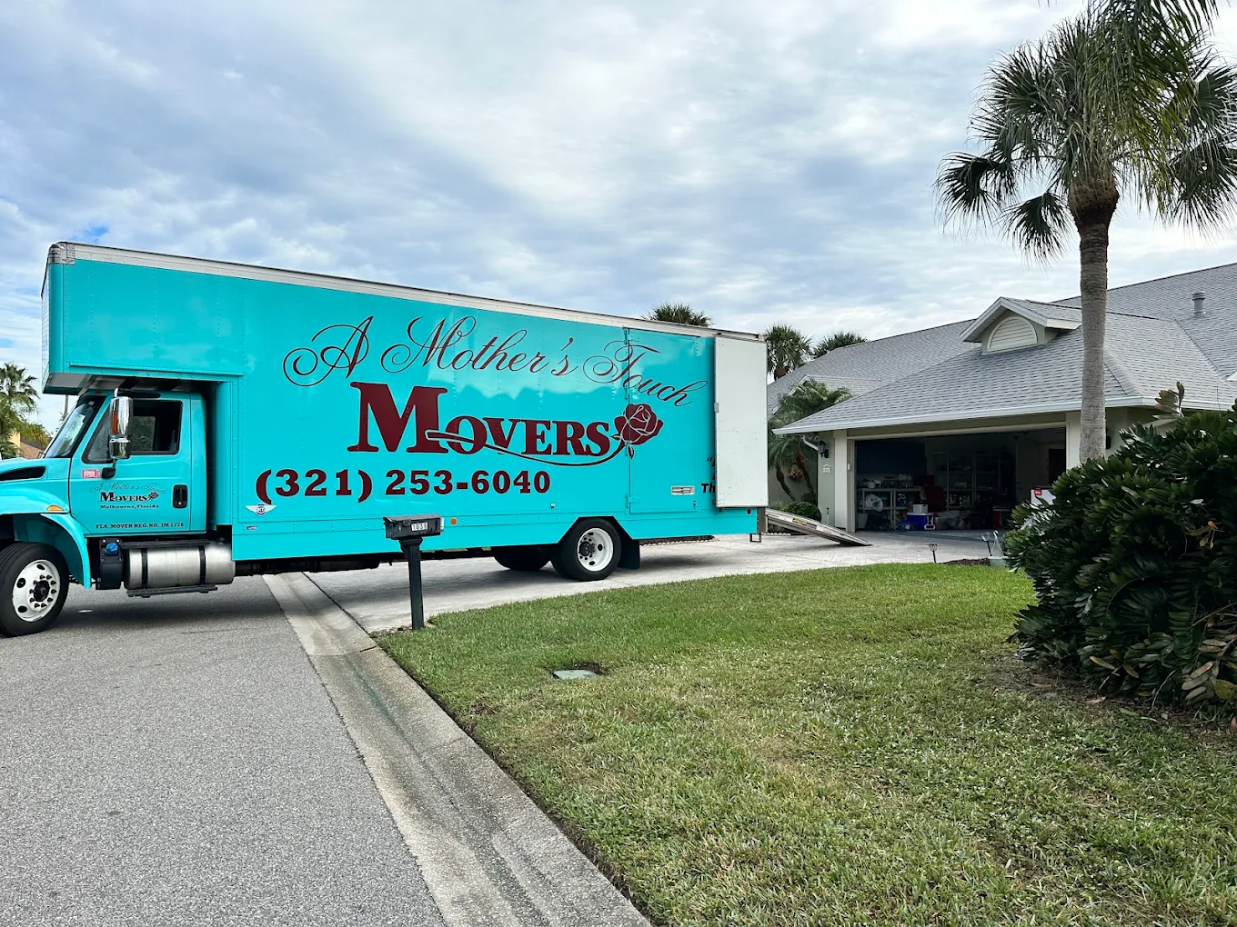 A Mother's Touch Moving truck parked in a driveway in Melbourne, Florida