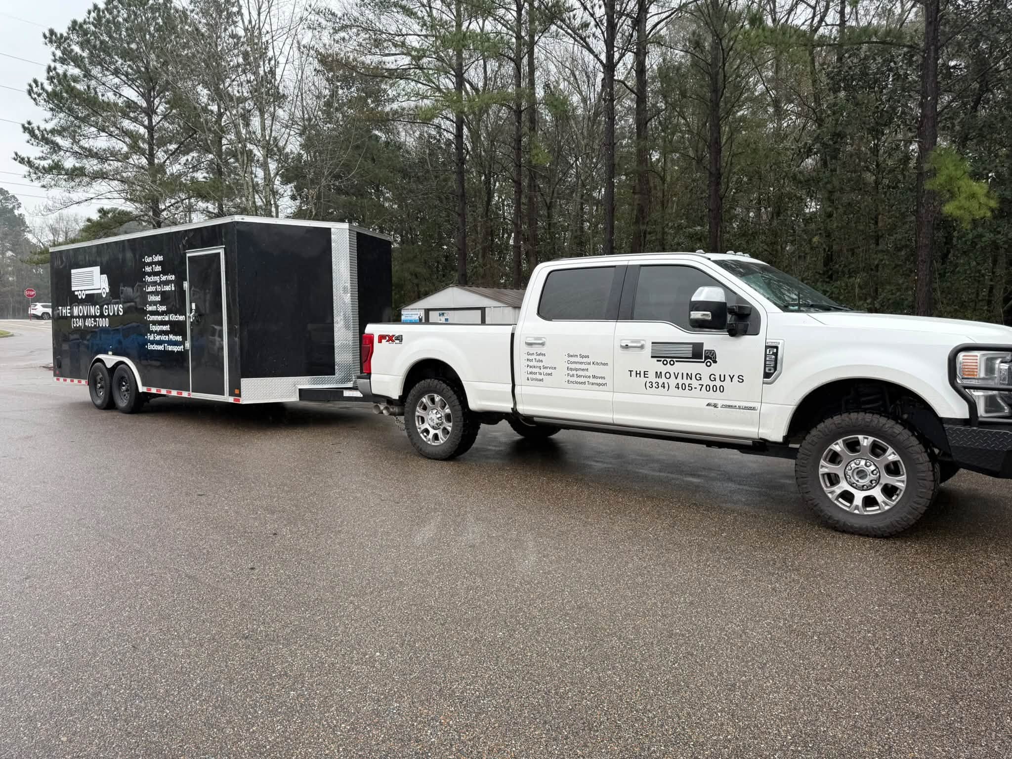 The Moving Guys truck and enclosed trailer branded for local moves in Enterprise, Alabama